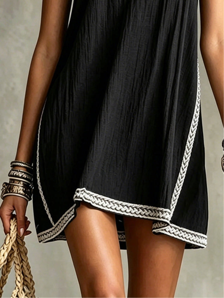 Black mini dress with spaghetti straps and piped trim