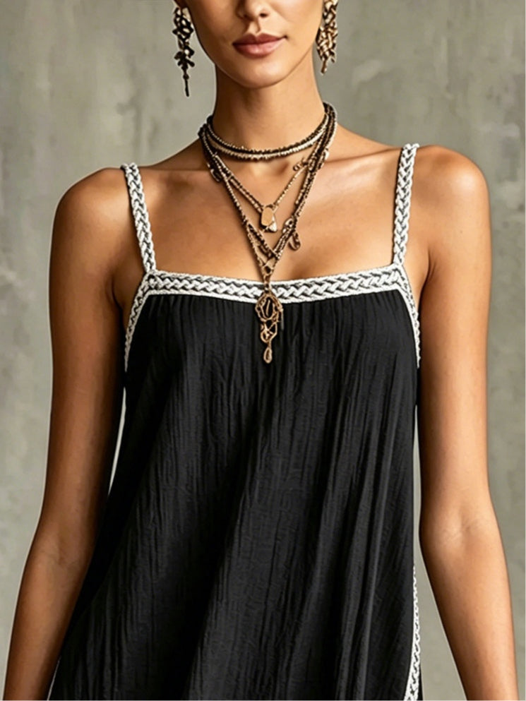 Black mini dress with spaghetti straps and piped trim